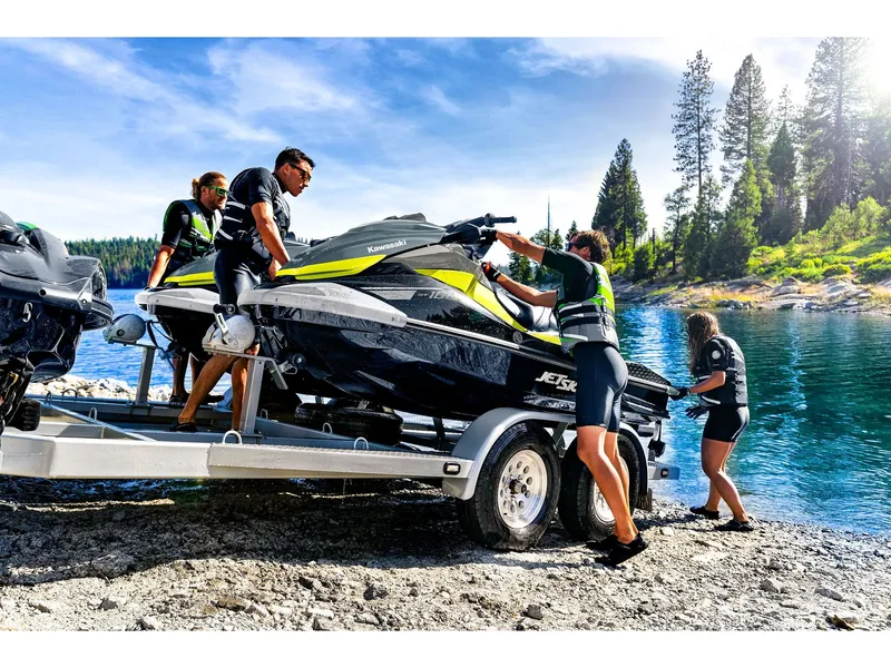 Slide: The Image of A group of people loading a Kawasaki Jet Ski ST 160X onto a trailer at the lakeside. - 18