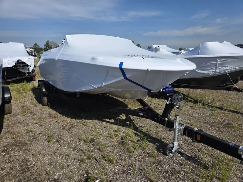The Image of A 2026 Bayliner 170 ELEMENT M17 is covered with a tarp and sits on a trailer. - 1