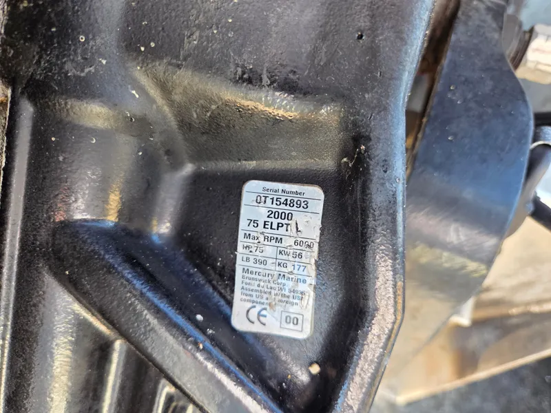 Slide: The Image of Close-up of a Mercury Marine engine with serial number and specifications. - 26