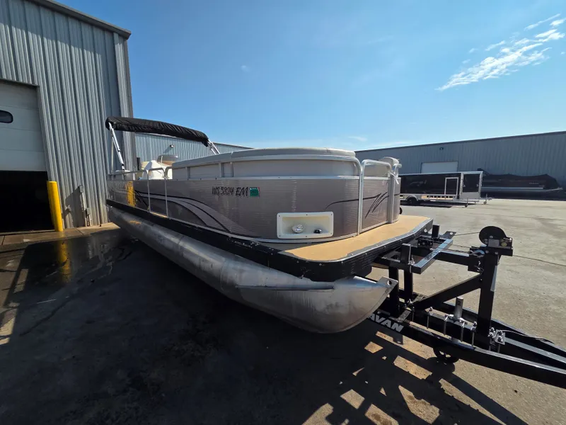 Slide: The Image of A 1998 Sylvan 826 Nexus pontoon boat on a trailer beside a building. - 7