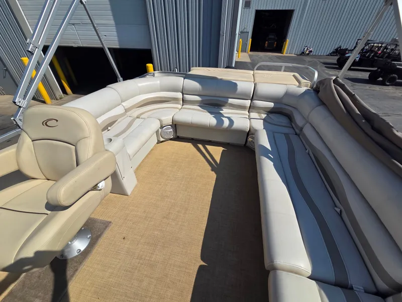 Slide: The Image of Interior of a 1998 Sylvan 826 Nexus pontoon boat with beige upholstered seating. - 18