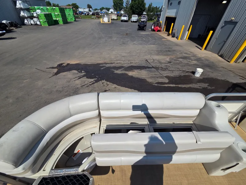 Slide: The Image of The image shows the interior of a Sylvan 826 Nexus pontoon boat with white seating. - 14