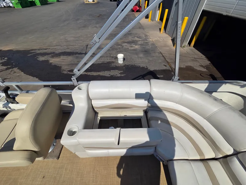 Slide: The Image of The image shows the seating area of a Sylvan 826 Nexus pontoon boat with beige upholstery. - 23