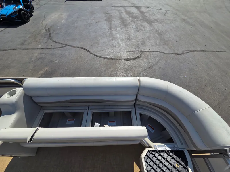 Slide: The Image of The image shows the deck of a 1998 Sylvan 826 Nexus pontoon boat with gray upholstery. - 15