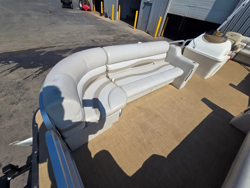 Slide: The Image of The image shows the deck of a 1998 Sylvan 826 Nexus with white cushioned seating. - 13