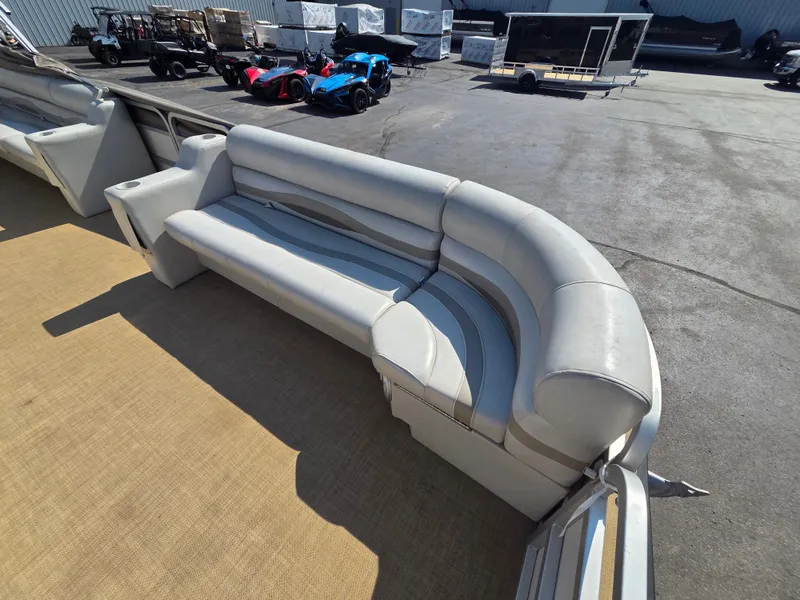 Slide: The Image of The image shows a white cushioned bench on a boat, surrounded by an open deck area. - 12