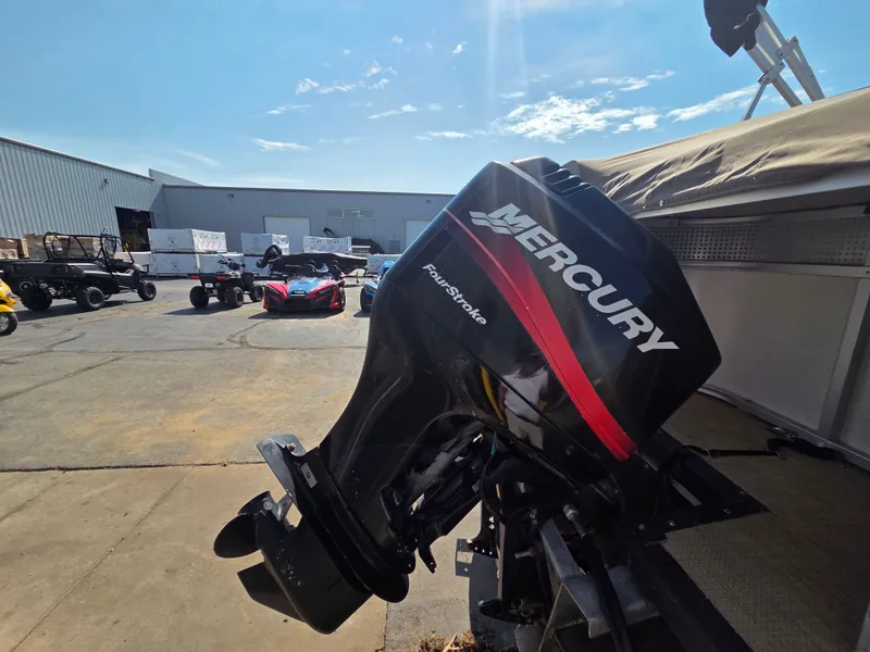 Slide: The Image of A Mercury outboard motor is attached to a boat on a trailer in a storage area. - 10