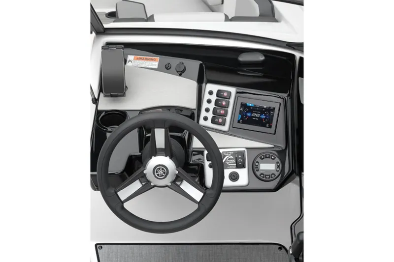 Slide: The Image of The image shows the helm of a Yamaha SX220 boat. It features a modern steering wheel, digital display, and various controls. - 2