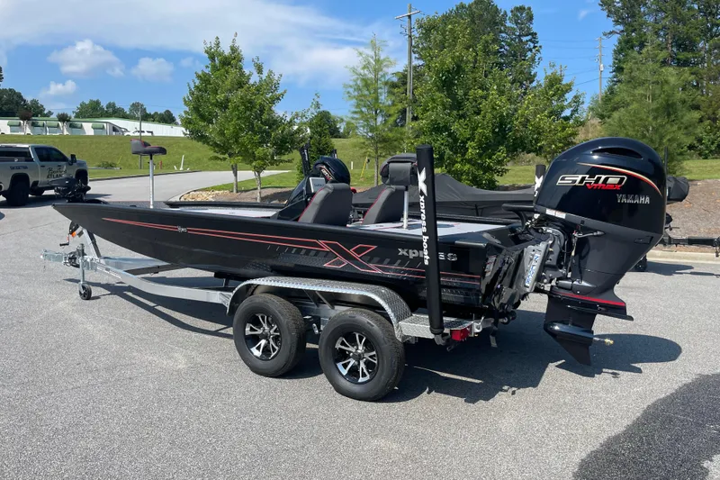 The Image of 2027 Xpress H20 Bass boat with Yamaha engine on a trailer, parked outdoors. - 0