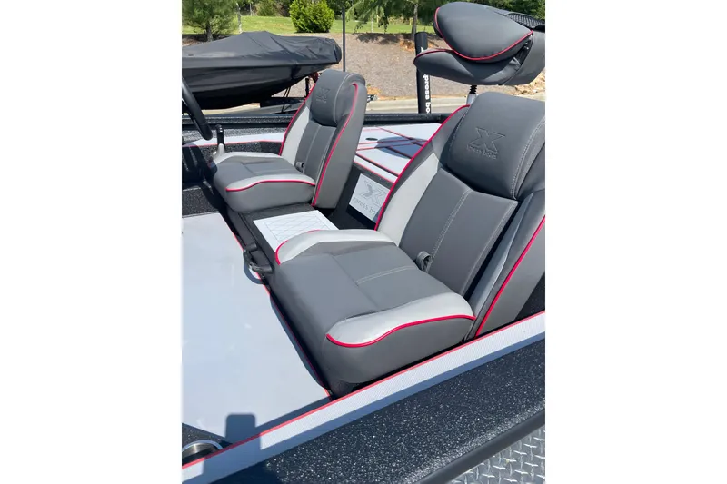 Slide: The Image of 2027 Xpress H20 Bass boat interior with gray and red seats. - 4