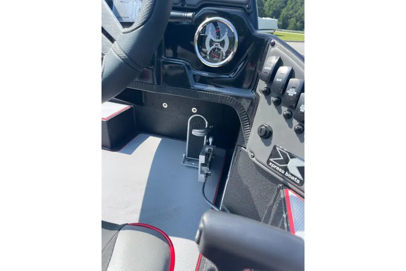 Slide: The Image of 2027 Xpress H20 Bass boat dashboard with steering wheel and control switches. - 9