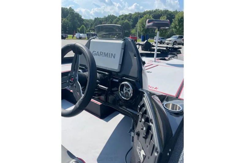Slide: The Image of 2027 Xpress H20 Bass boat dashboard with Garmin navigation system, steering wheel, and control panel. - 8