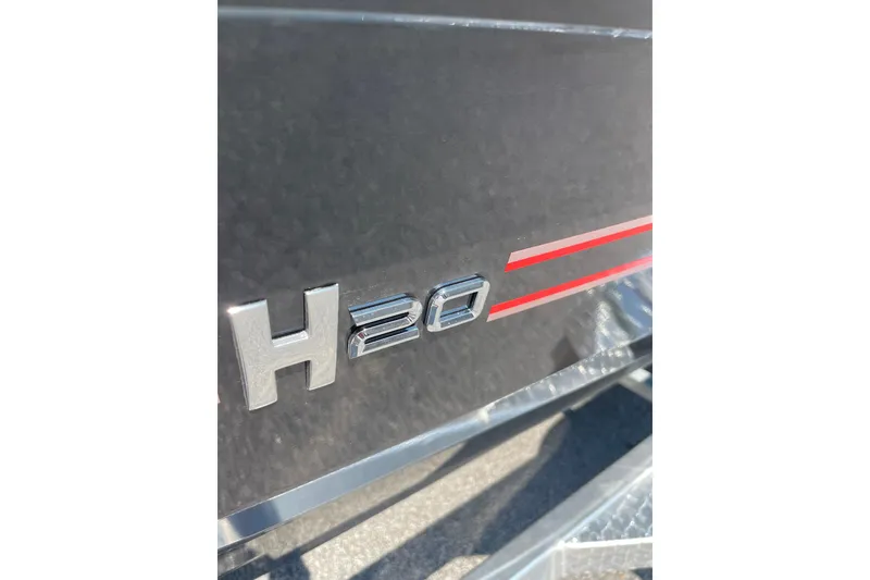 Slide: The Image of Close-up of 2027 Xpress H20 Bass boat emblem with red stripes. - 5