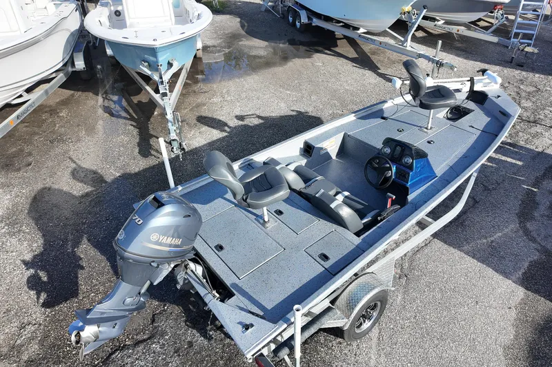 Slide: The Image of 2016 Xpress XP7 fishing boat with Yamaha motor on trailer, parked outdoors. - 4