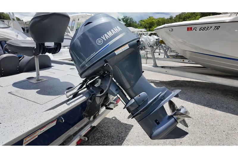 Slide: The Image of 2016 Xpress XP7 boat with Yamaha outboard motor, parked on a trailer. - 5