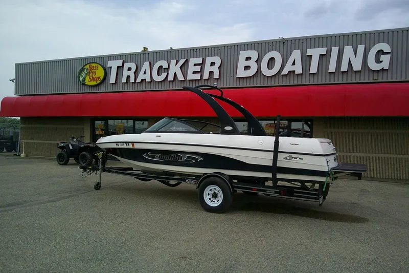 Slide: The Image of 2005 Malibu iRide boat on trailer outside Tracker Boating store. - 2