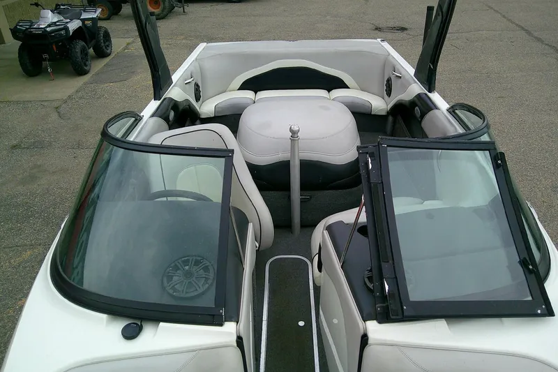 Slide: The Image of Interior of a 2005 Malibu iRide boat with white seating and open windshield. - 8