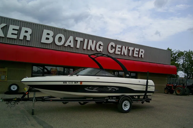 Slide: The Image of 2005 Malibu iRide boat on trailer at a boating center. - 1