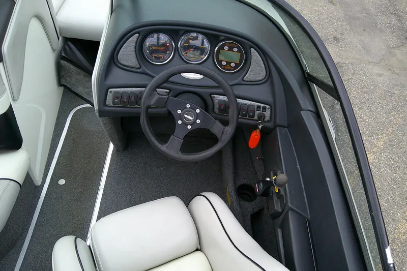 Slide: The Image of 2005 Malibu iRide boat dashboard with steering wheel and instrument panel. - 9