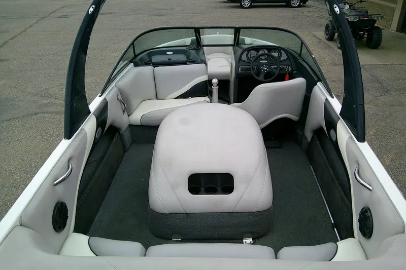 Slide: The Image of 2005 Malibu iRide boat interior with white seating and steering wheel, showcasing spacious design. - 6
