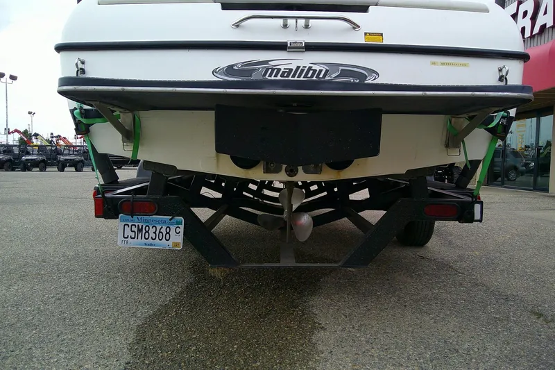 Slide: The Image of Rear view of a 2005 Malibu iRide boat on a trailer in a parking lot. - 10