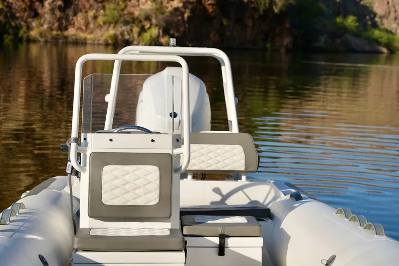 Slide: The Image of 2027 Tide Craft Kodiak 16 boat on calm water, featuring sleek design and modern seating. - 7