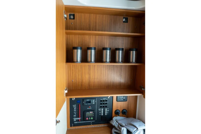 Slide: The Image of 2023 Solace 41CS interior cabinet with control panel and storage shelves. - 68