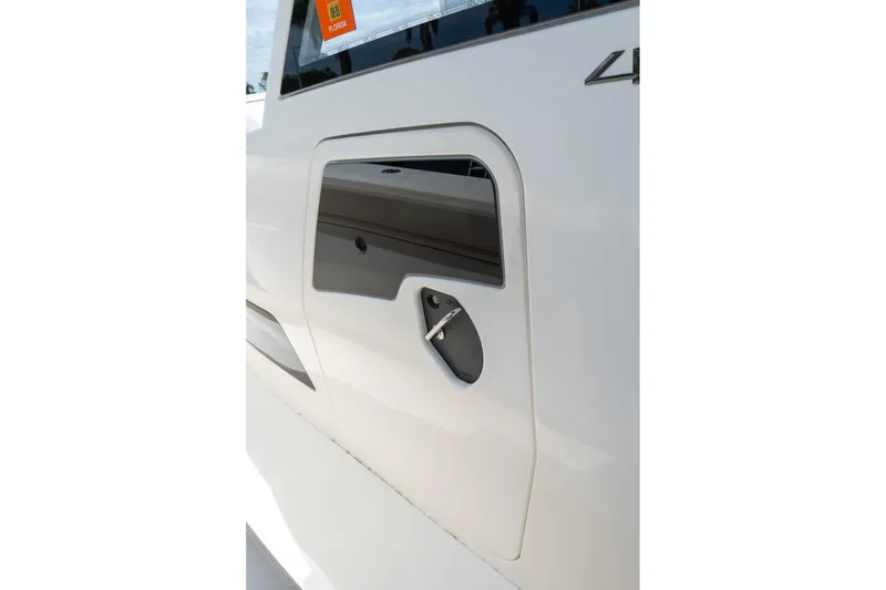 Slide: The Image of Close-up of a 2023 Solace 41CS boat's side panel and window detail. - 66
