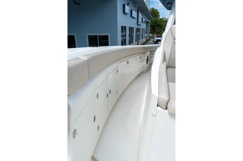 Slide: The Image of 2023 Solace 41CS boat interior with sleek white seating and storage compartments. - 64
