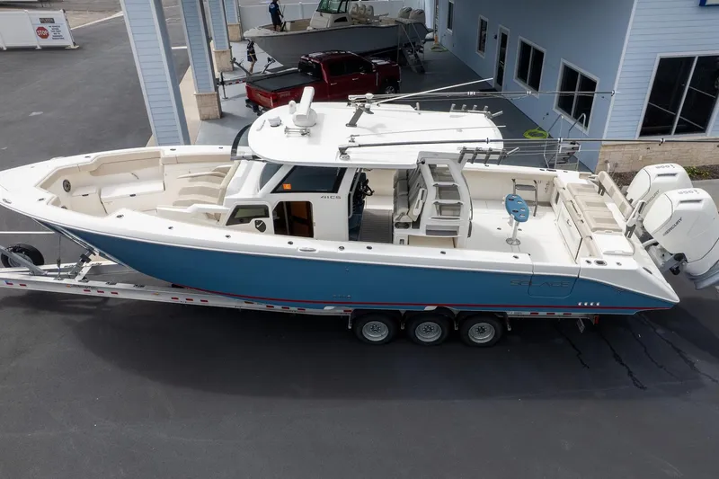 Slide: The Image of 2023 Solace 41CS boat on trailer, featuring sleek design and powerful engines. - 4