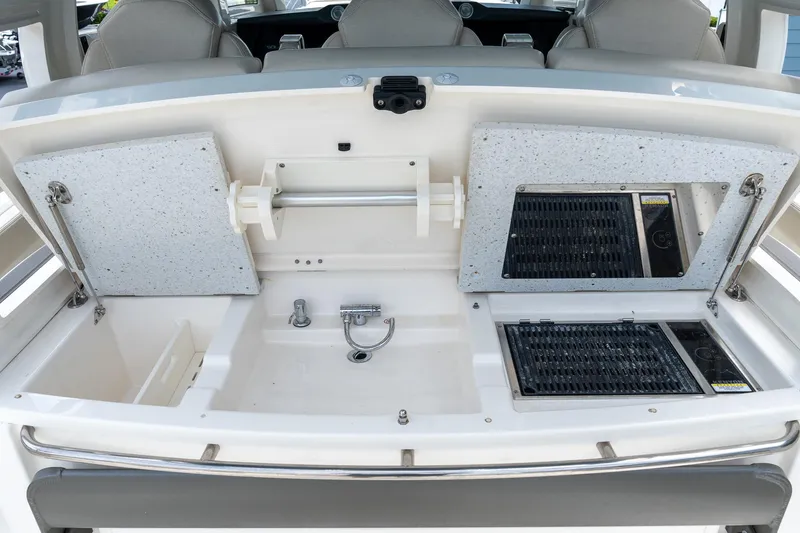 Slide: The Image of 2023 Solace 41CS boat galley with sink, grill, and storage compartments. - 40