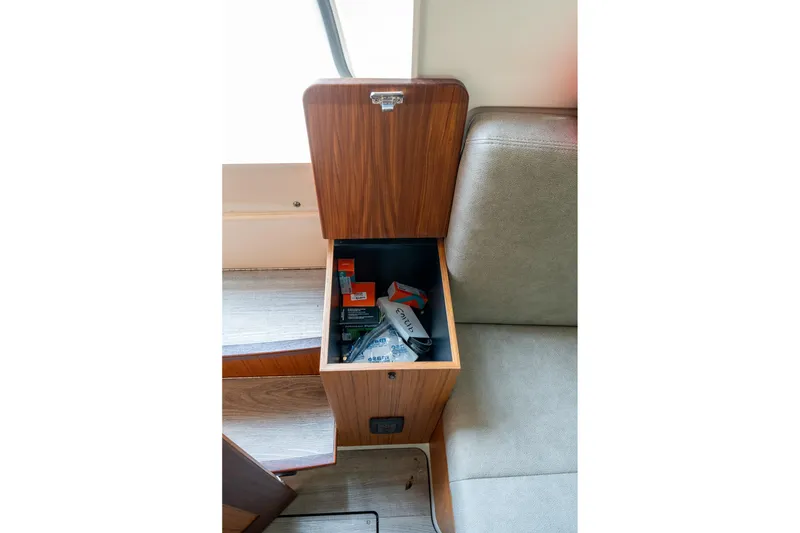 Slide: The Image of Open storage compartment in 2023 Solace 41CS boat, containing various items. - 12
