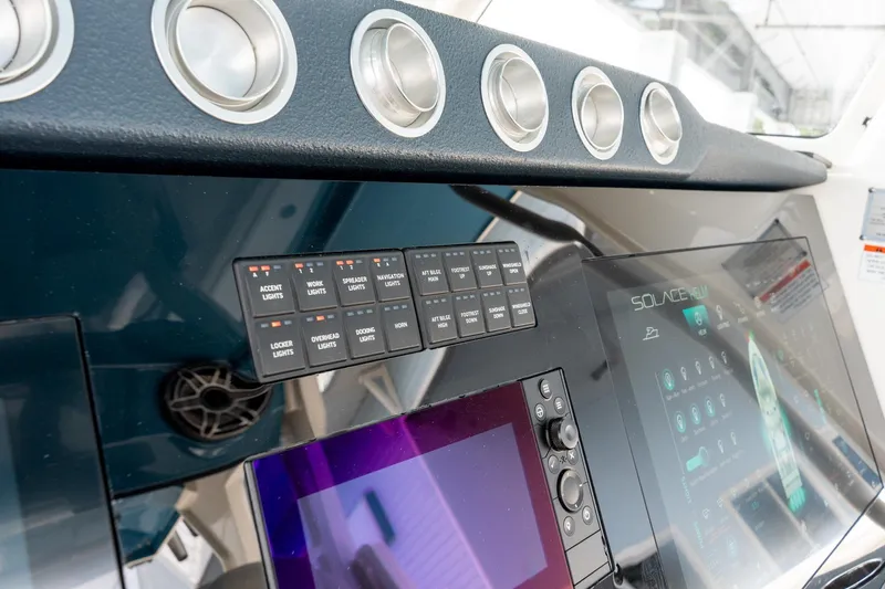 Slide: The Image of Control panel of 2023 Solace 41CS boat with digital displays and switches. - 48