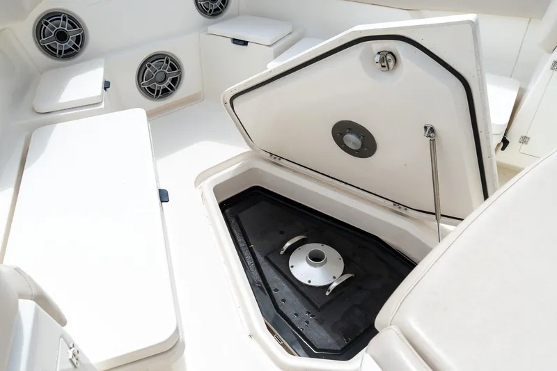 Slide: The Image of 2023 Solace 41CS boat interior with open storage compartment and speakers. - 59