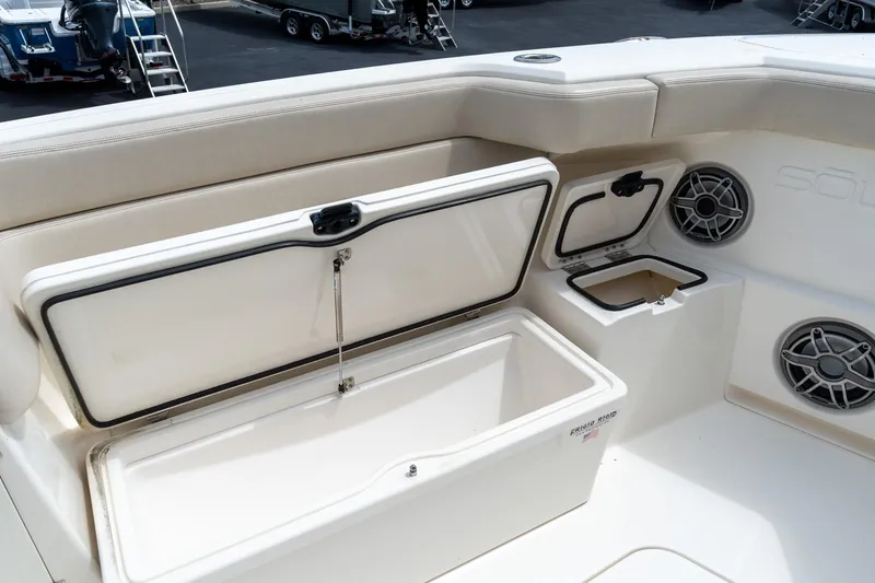 Slide: The Image of 2023 Solace 41CS boat interior with open storage compartments and speakers. - 58