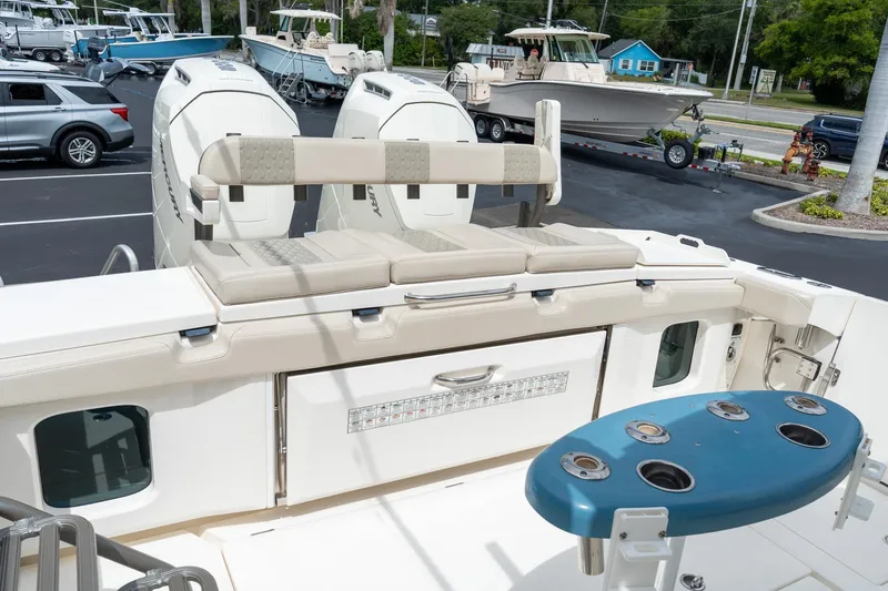 Slide: The Image of 2023 Solace 41CS boat with dual engines, cushioned seating, and fishing rod holders. - 26