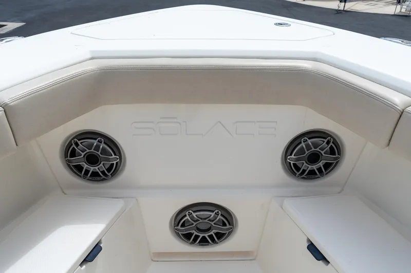 Slide: The Image of Interior view of 2023 Solace 41CS boat with speakers and cushioned seating. - 60