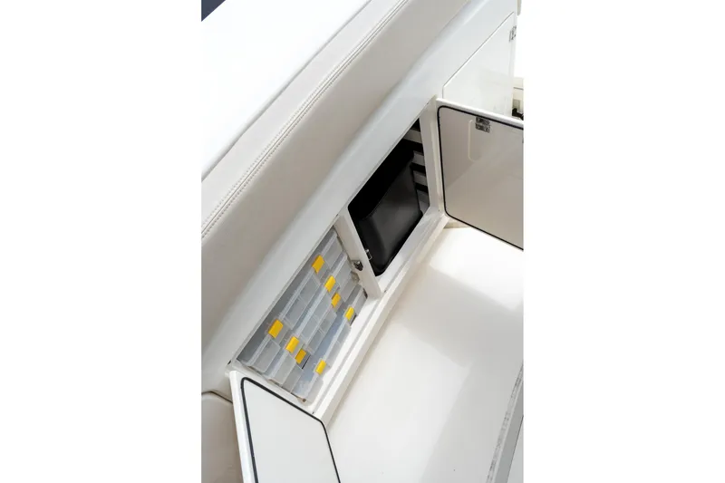 Slide: The Image of 2023 Solace 41CS boat storage compartment with organized tackle boxes and open hatch. - 55