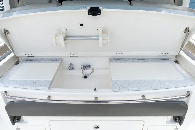 Slide: The Image of 2023 Solace 41CS boat kitchen area with sink and cutting boards. - 39
