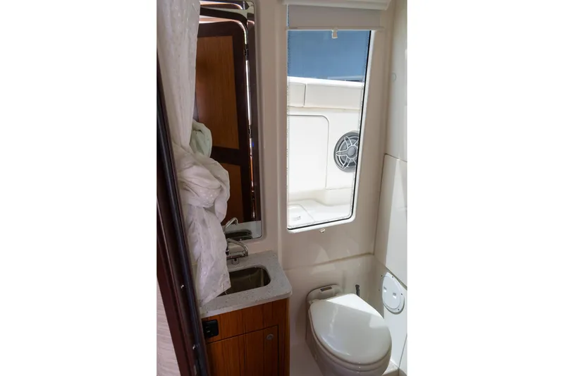 Slide: The Image of 2023 Solace 41CS boat bathroom interior with sink, toilet, and window. - 10