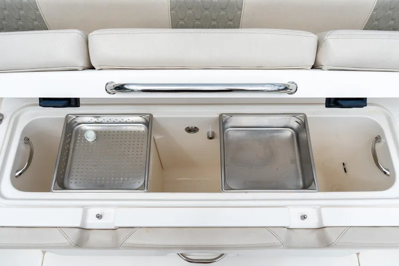 Slide: The Image of 2023 Solace 41CS boat storage compartment with stainless steel trays and cushioned seating. - 30