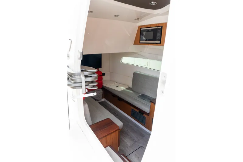 Slide: The Image of Interior view of 2023 Solace 41CS boat cabin with seating and microwave. - 13
