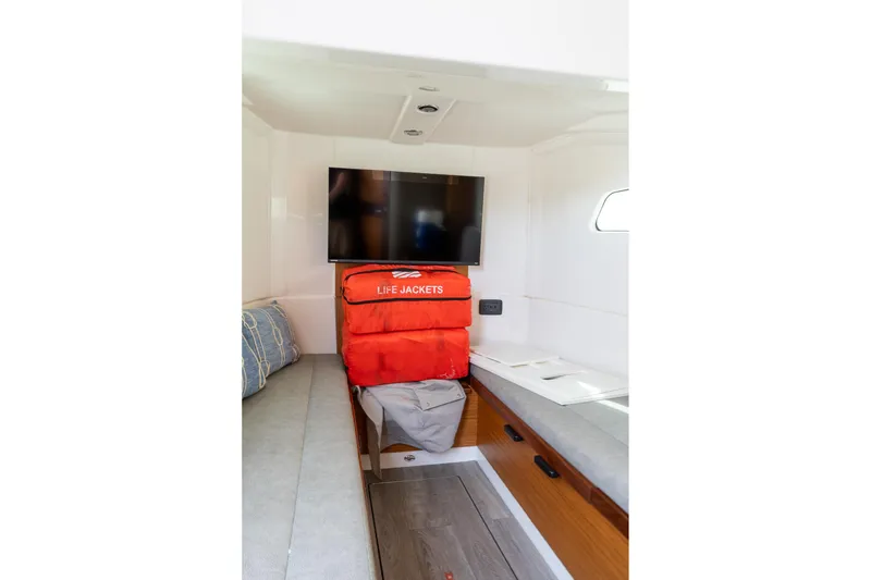 Slide: The Image of 2023 Solace 41CS cabin interior with life jackets and TV. - 70