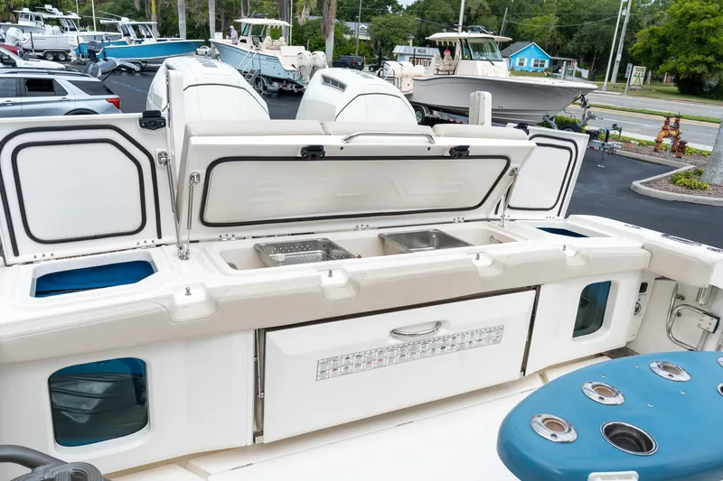 Slide: The Image of 2023 Solace 41CS boat with open storage compartments and fishing amenities. - 27