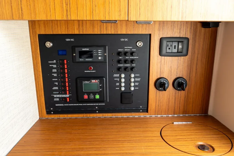 Slide: The Image of Electrical control panel in 2023 Solace 41CS boat, featuring 120V AC and 12V DC systems. - 67