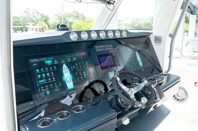 Slide: The Image of 2023 Solace 41CS boat helm with advanced digital displays and steering wheel. - 46