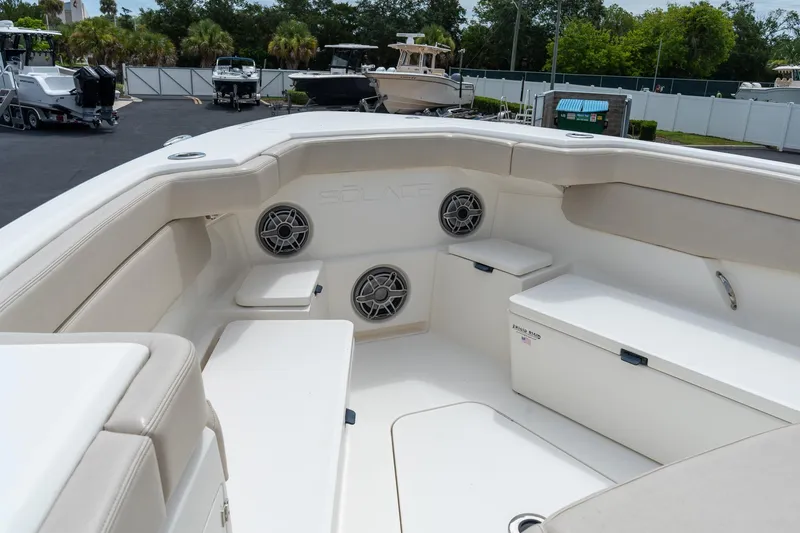Slide: The Image of 2023 Solace 41CS boat interior with cushioned seating and built-in speakers. - 57