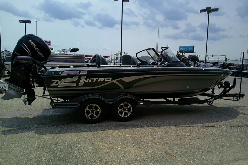 Slide: The Image of 2018 Nitro ZV21 boat with Mercury engine on a trailer in a parking lot. - 3