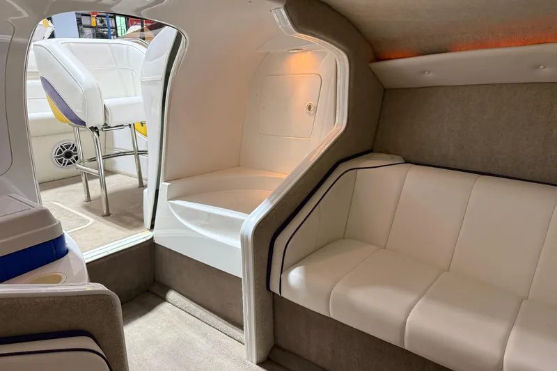 Slide: The Image of Interior of a 2002 Nordic Boats 28' Heat, featuring white seating and modern design. - 27