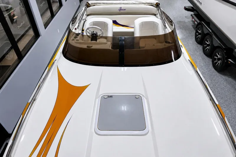Slide: The Image of 2002 Nordic Boats 28' Heat with sleek design and vibrant orange graphics in showroom. - 10